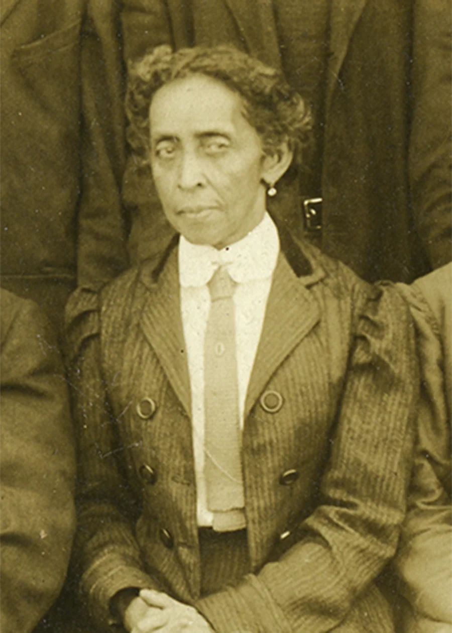 Sepia photograph of Florence Stanton Barber, seated, wearing a striped double-breasted jacket, white collar and tie